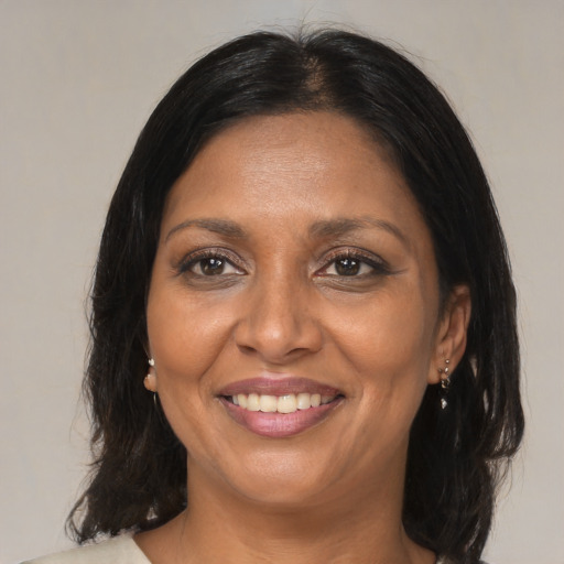 Joyful asian adult female with medium  brown hair and brown eyes