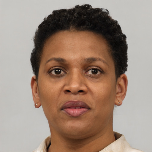 Joyful black adult female with short  brown hair and brown eyes