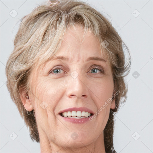 Joyful white adult female with medium  brown hair and blue eyes