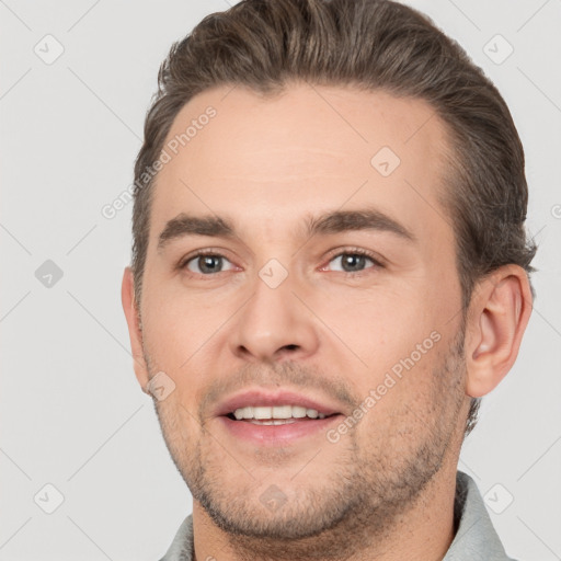 Joyful white young-adult male with short  brown hair and brown eyes