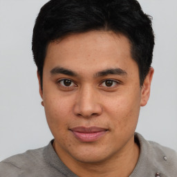 Joyful asian young-adult male with short  brown hair and brown eyes