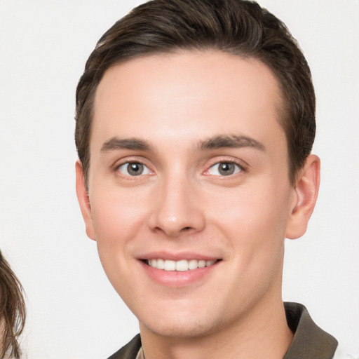 Joyful white young-adult male with short  brown hair and brown eyes