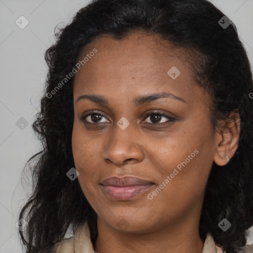 Joyful black young-adult female with long  brown hair and brown eyes