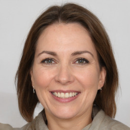 Joyful white adult female with medium  brown hair and brown eyes