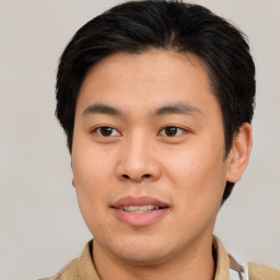 Joyful asian young-adult male with short  brown hair and brown eyes