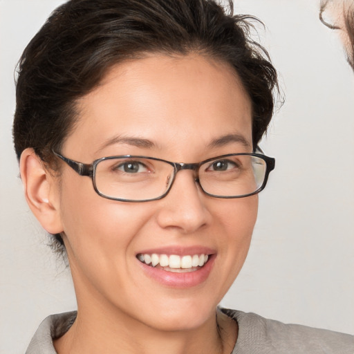 Joyful white young-adult female with medium  brown hair and brown eyes