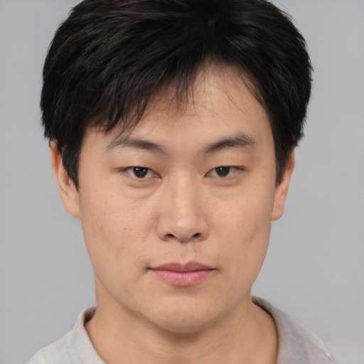 Neutral asian young-adult male with short  brown hair and brown eyes