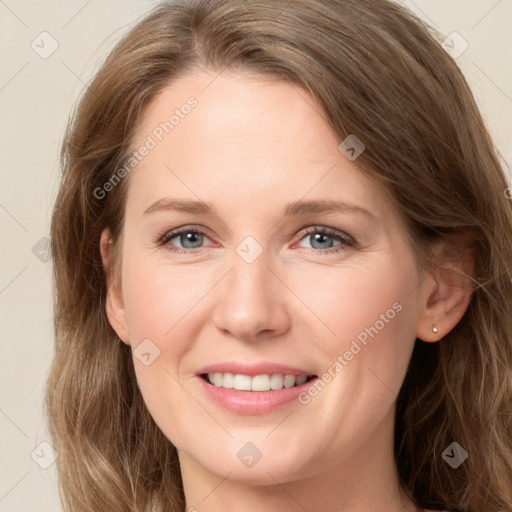 Joyful white adult female with long  brown hair and grey eyes