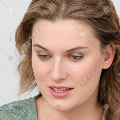 Joyful white young-adult female with medium  brown hair and blue eyes