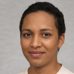 Joyful latino young-adult female with short  brown hair and brown eyes