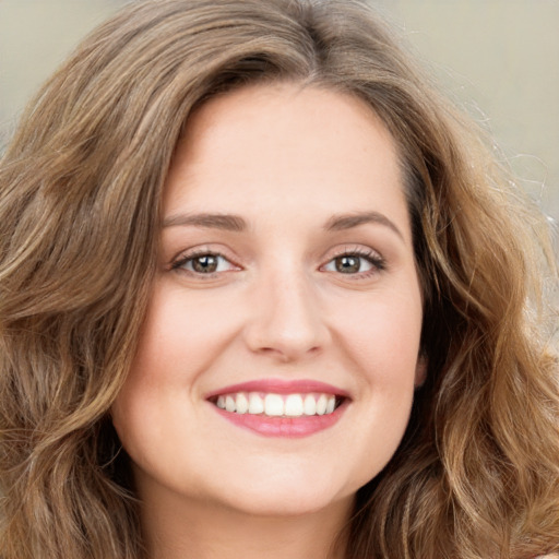 Joyful white young-adult female with long  brown hair and green eyes