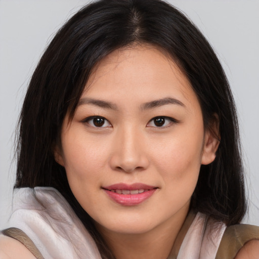 Joyful asian young-adult female with long  brown hair and brown eyes