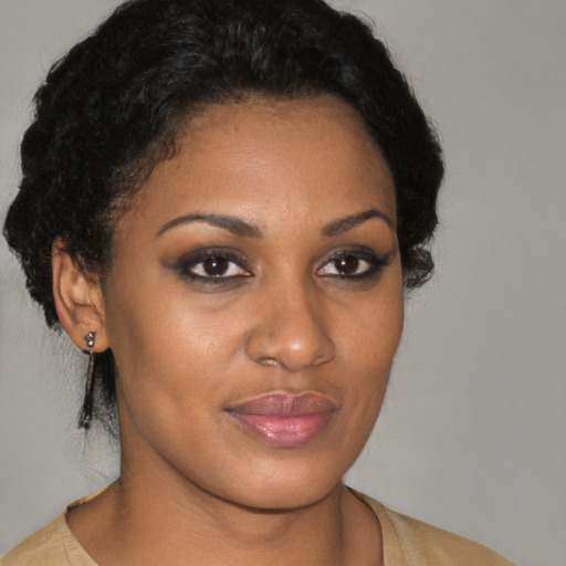 Joyful black young-adult female with short  brown hair and brown eyes