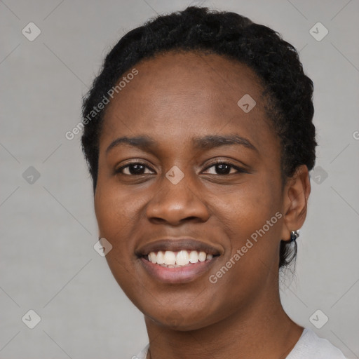 Joyful black young-adult female with short  black hair and brown eyes