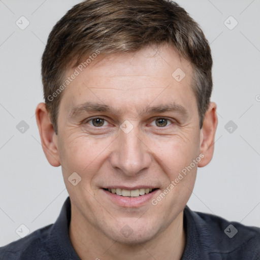 Joyful white adult male with short  brown hair and brown eyes