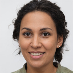 Joyful latino young-adult female with medium  brown hair and brown eyes