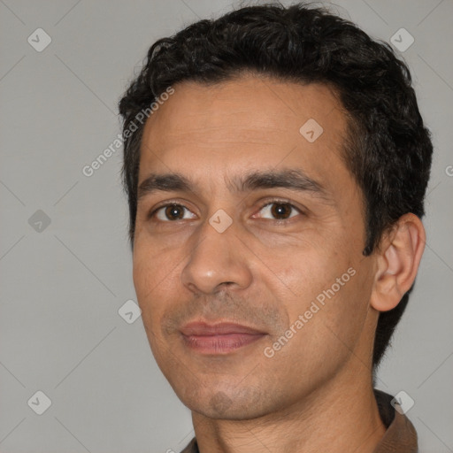 Joyful white adult male with short  black hair and brown eyes