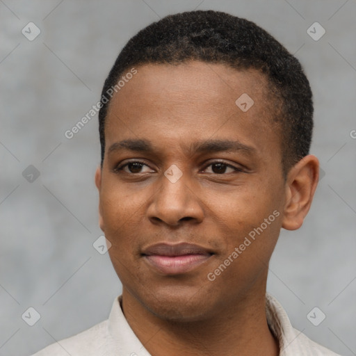 Joyful latino young-adult male with short  brown hair and brown eyes