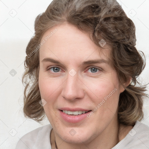 Joyful white young-adult female with medium  brown hair and blue eyes