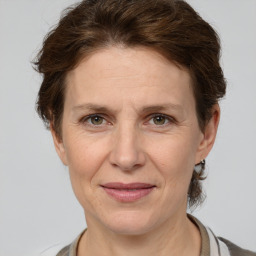 Joyful white adult female with medium  brown hair and grey eyes