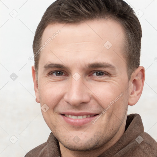 Joyful white young-adult male with short  brown hair and grey eyes