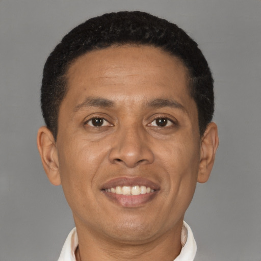 Joyful latino adult male with short  brown hair and brown eyes