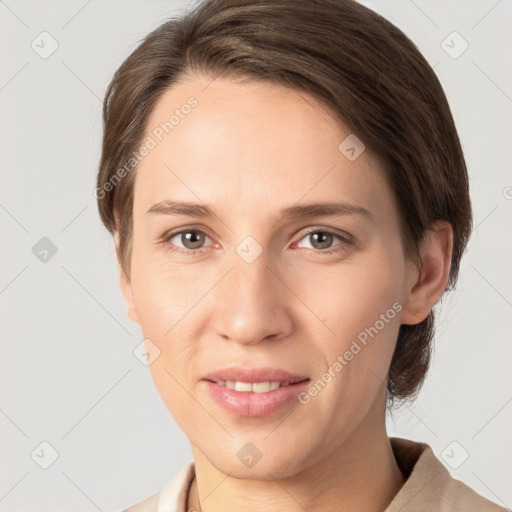 Joyful white young-adult female with medium  brown hair and grey eyes