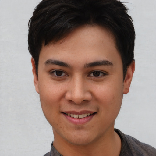 Joyful asian young-adult female with short  brown hair and brown eyes