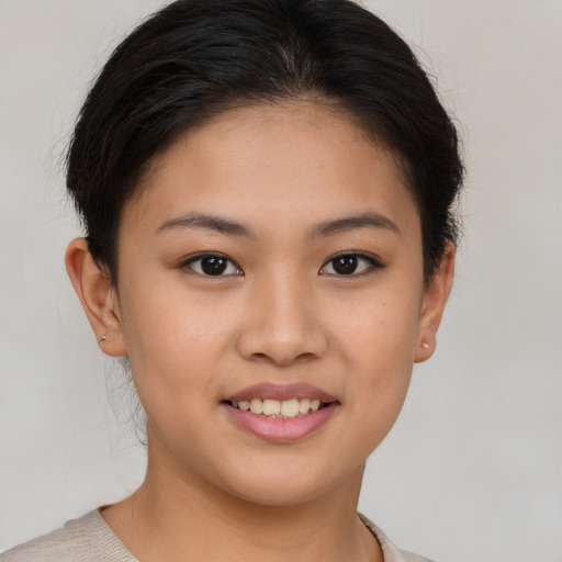 Joyful asian young-adult female with short  brown hair and brown eyes