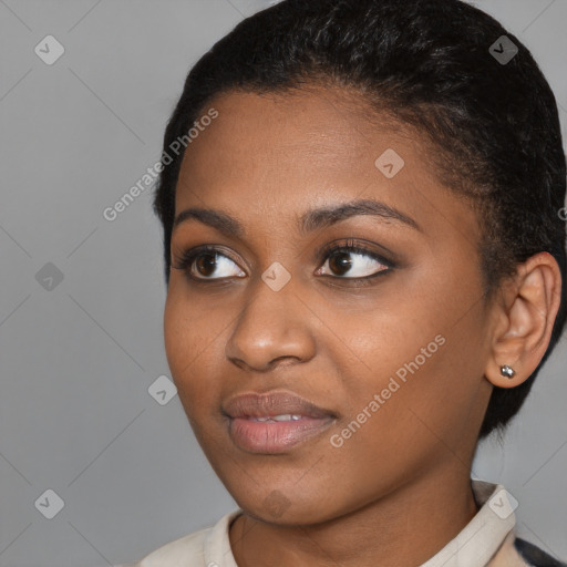 Joyful black young-adult female with short  black hair and brown eyes