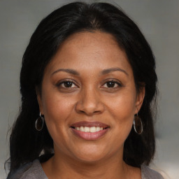 Joyful black adult female with medium  brown hair and brown eyes