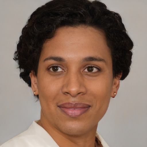 Joyful latino adult female with short  brown hair and brown eyes