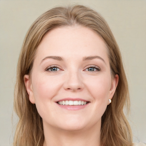 Joyful white young-adult female with long  brown hair and blue eyes