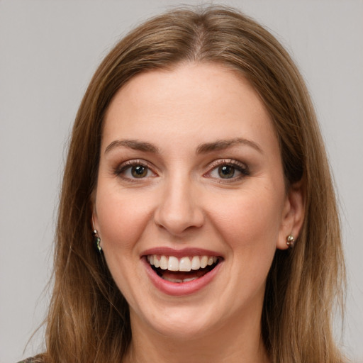 Joyful white young-adult female with long  brown hair and green eyes