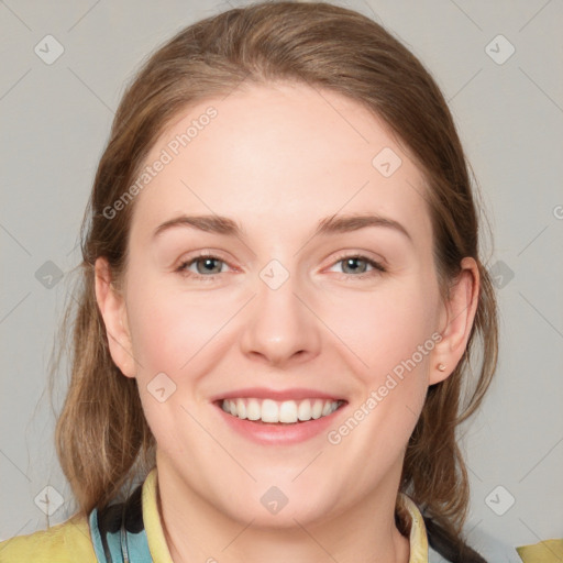 Joyful white young-adult female with medium  brown hair and blue eyes