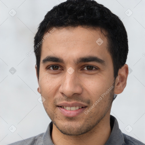 Joyful white young-adult male with short  black hair and brown eyes