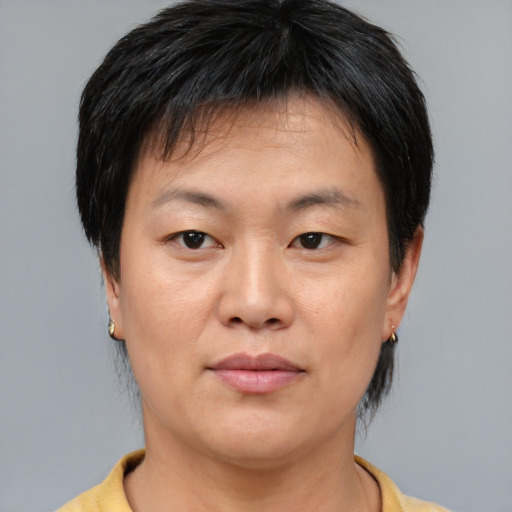 Joyful asian young-adult female with short  brown hair and brown eyes