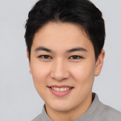 Joyful asian young-adult female with short  brown hair and brown eyes