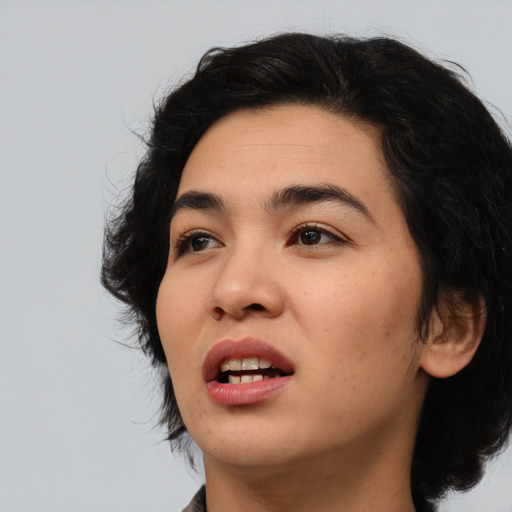 Joyful asian young-adult female with medium  black hair and brown eyes