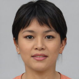 Joyful asian young-adult female with short  brown hair and brown eyes