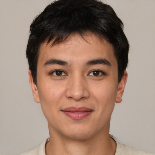 Joyful asian young-adult male with short  black hair and brown eyes