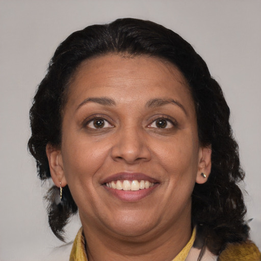 Joyful black adult female with medium  brown hair and brown eyes
