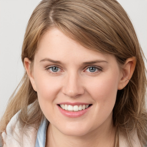 Joyful white young-adult female with long  brown hair and grey eyes