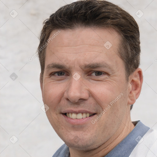 Joyful white adult male with short  brown hair and brown eyes