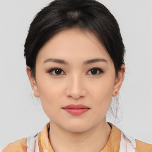 Joyful asian young-adult female with medium  black hair and brown eyes