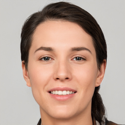 Joyful white young-adult female with medium  brown hair and brown eyes