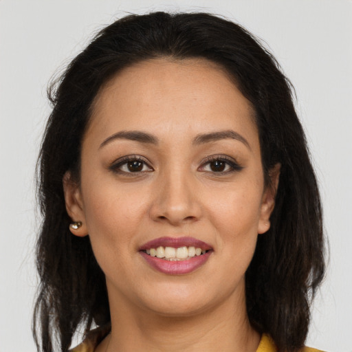 Joyful white young-adult female with long  brown hair and brown eyes