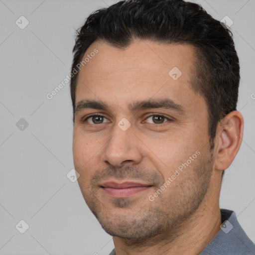 Joyful white young-adult male with short  black hair and brown eyes