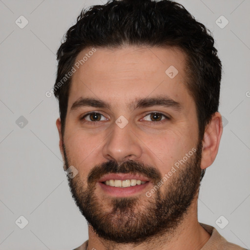 Joyful white young-adult male with short  black hair and brown eyes