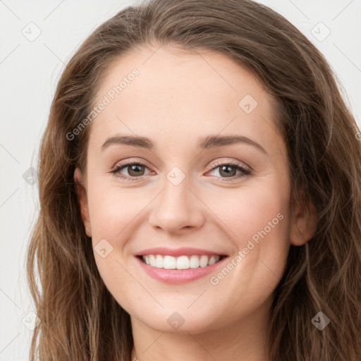 Joyful white young-adult female with long  brown hair and green eyes